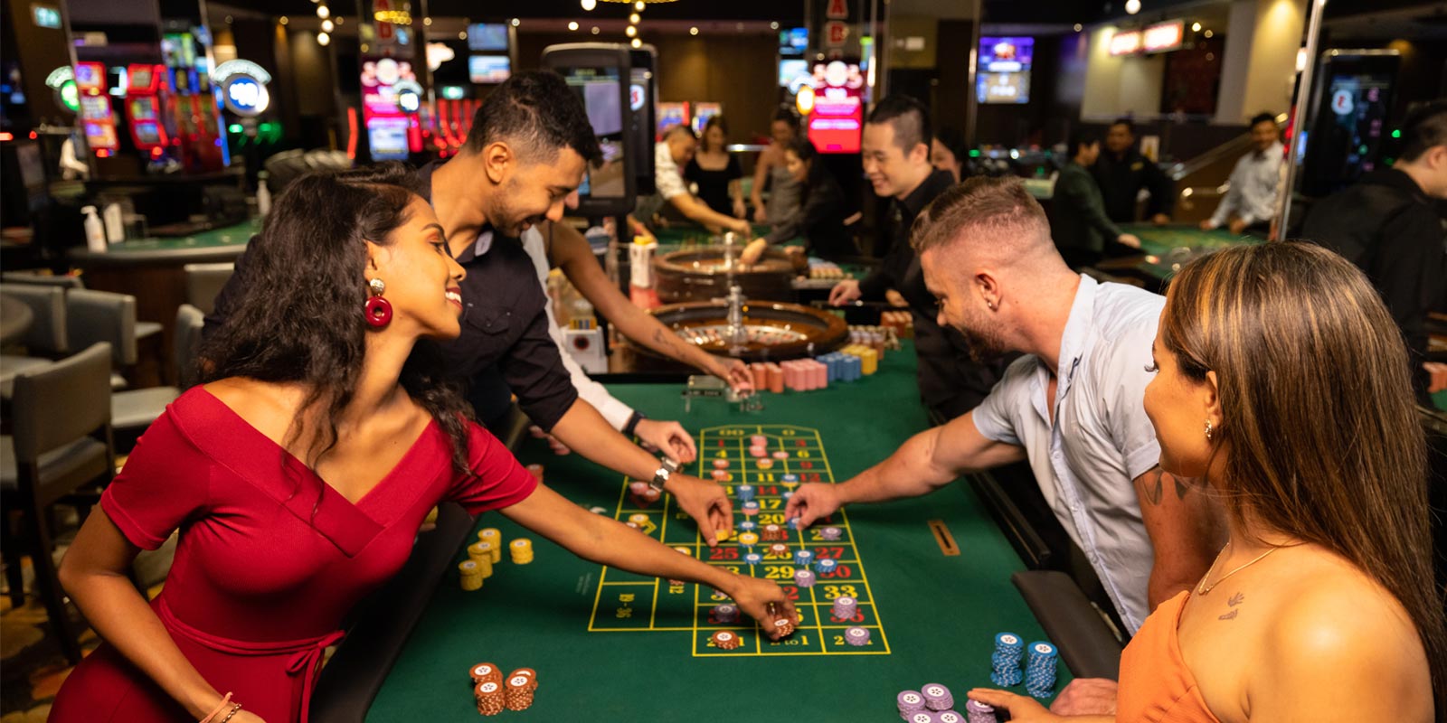 Group of people placing chips on the casino table game.