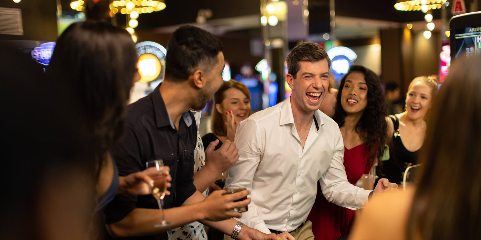 Crowd cheering for a person winning at the casino.