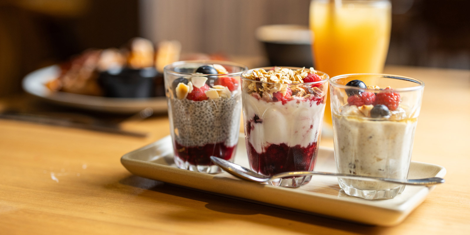 Yogurt and berries on a serving dish with spoon.