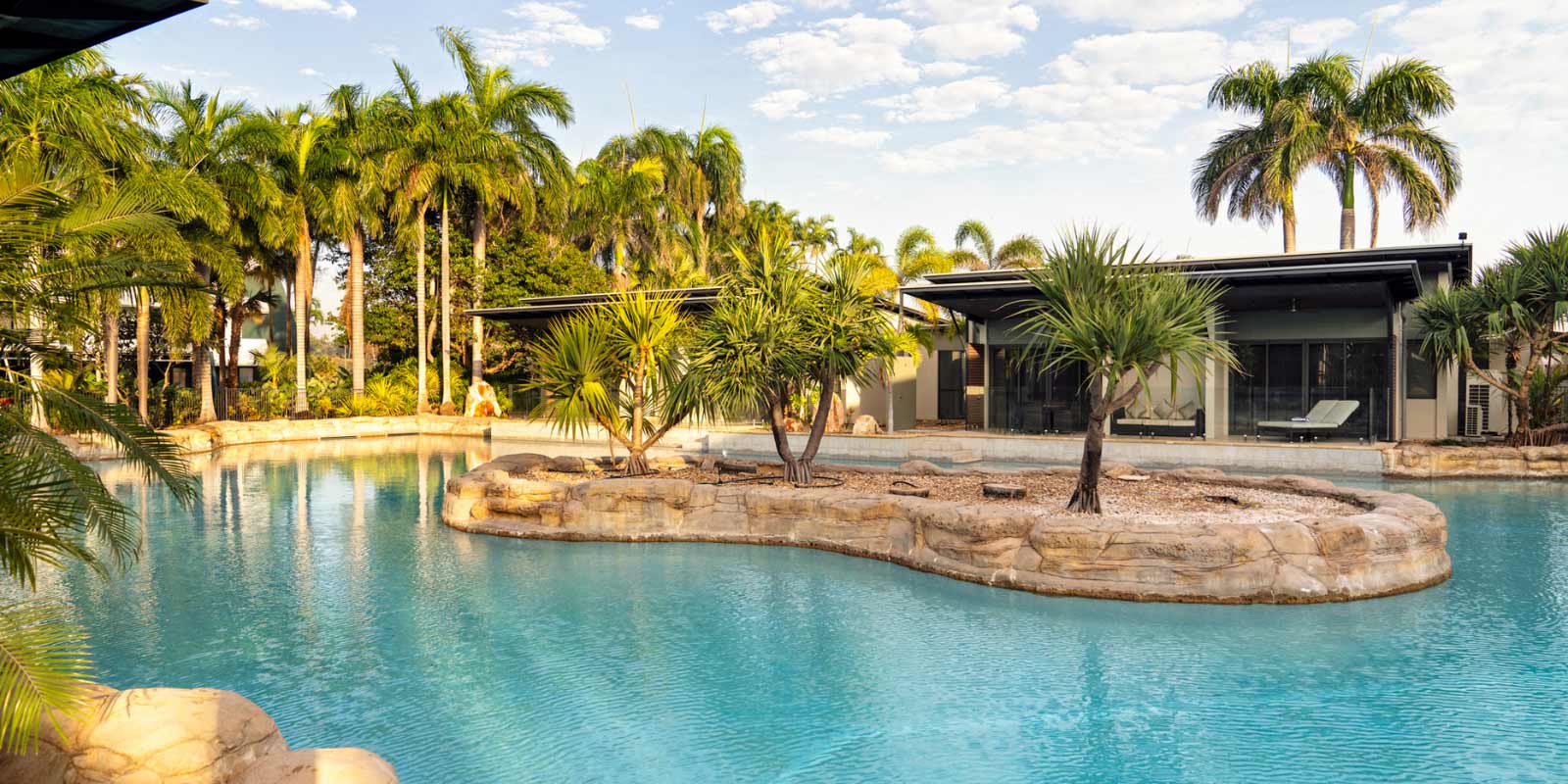 View of the resort pool featuring palm trees.